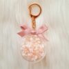 Pink and white baby’s breath preserved floral charm in acrylic case