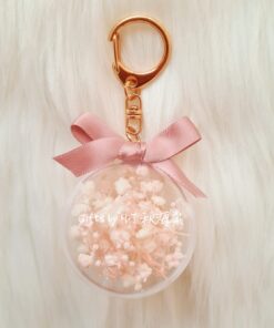 Pink and white baby’s breath preserved floral charm in acrylic case
