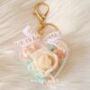 Preserved rose and hydrangea floral charm in clear acrylic case