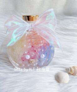 Ocean inspired herbarium aroma bottle with preserved flowers and seashell details